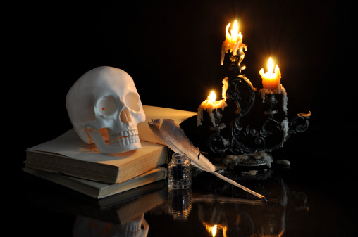 Still life with skull, books and melting candles